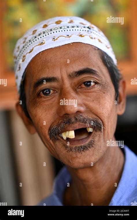 Jakarta, Indonesia. Happy smiling man with missing teeth. PICTURE BY ...