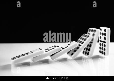 Row of Domino Tiles falling Stock Photo - Alamy