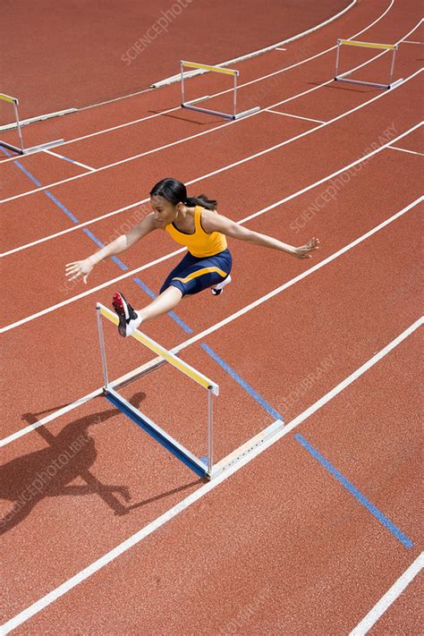 Athlete jumping over a hurdle - Stock Image - P960/0605 - Science Photo ...