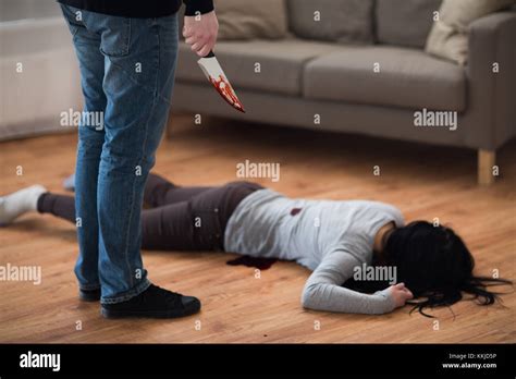 criminal with knife and dead body at crime scene Stock Photo - Alamy