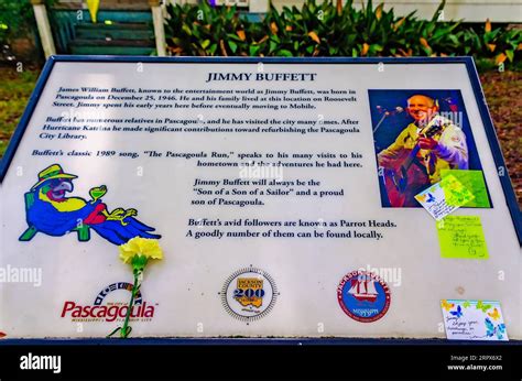 Flowers and notes are left on a plaque at Jimmy Buffett’s childhood home, Sept. 2, 2023, in ...