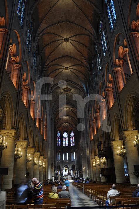 Inside of Notre Dame cathedral in Paris looking down the aisle | FIN