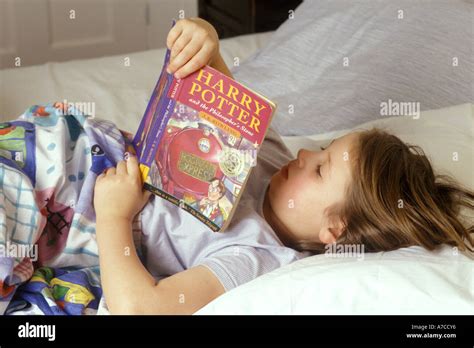 girl reading book in bed Stock Photo - Alamy