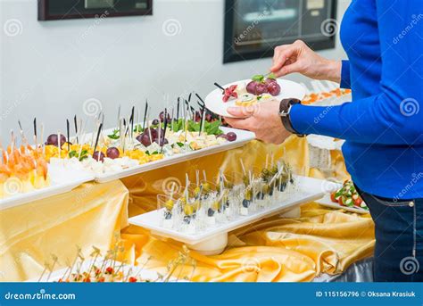 Catering Buffet Table with Food and Snacks for Guests of the Event. Group of People in All You ...