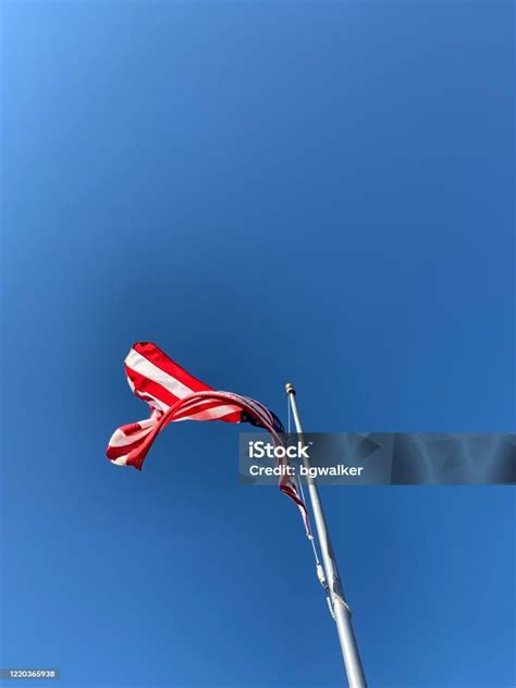 American Flag Flying On Windy Day Stock Photo - Download Image Now ...