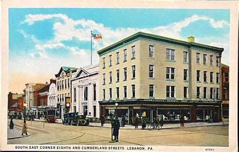 an old postcard shows people walking in front of a large building on ...