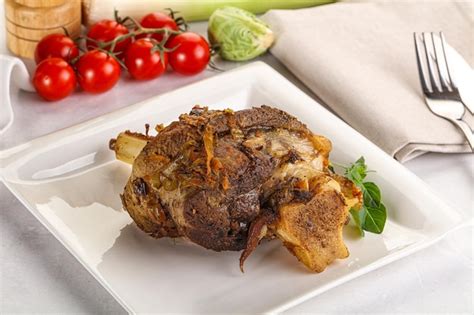 Premium Photo | Baked lamb shank with bone marinated in spices