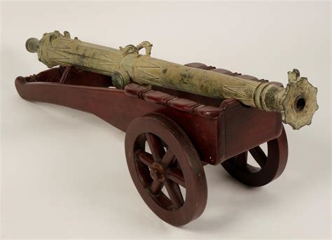 AN INDONESIAN BRONZE LANTAKA SWIVEL CANNON, the barrel with a cylindrical grip to the moulded cas