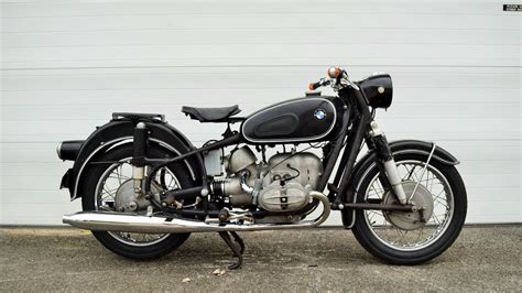 a black motorcycle parked on top of a sidewalk