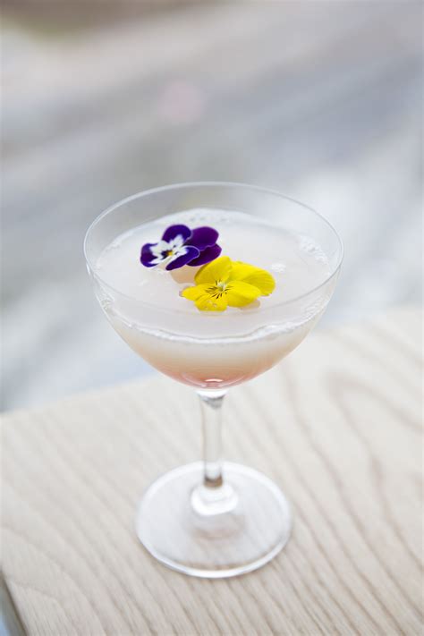 Pansy floral flower cocktail drink in a tall glass. Delicate alcoholic drink | Restaurant ...