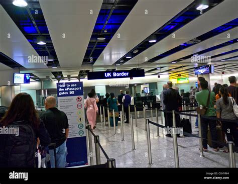 UK biometric passport Border Control queue for arriving passengers at London Heathrow airport ...