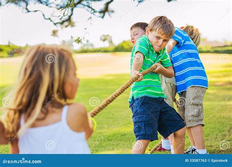 Kids playing Tug of War stock image. Image of black, group - 33587763