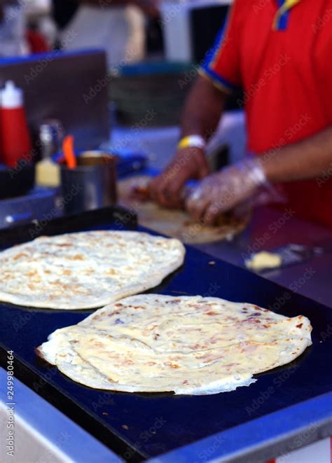 Indian street food vendor make vegetable roll or frankie, rolling the flat bread or roti Stock ...