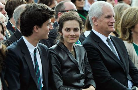 a group of people sitting next to each other in front of a crowd at an event