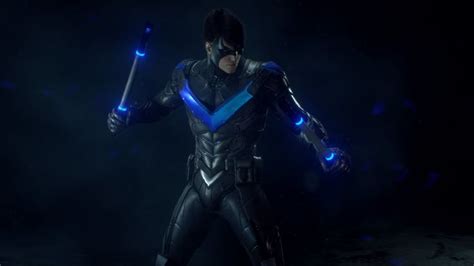 a man in a futuristic suit holding two blue lights