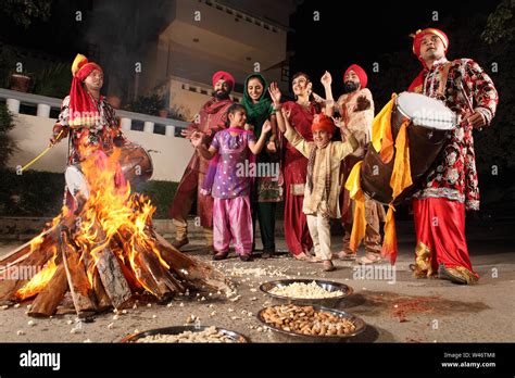 Family celebrating Lohri festival, Punjab, India Stock Photo - Alamy