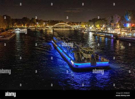 Bateau Mouche is cruising on the Seine River at night in Paris Stock ...