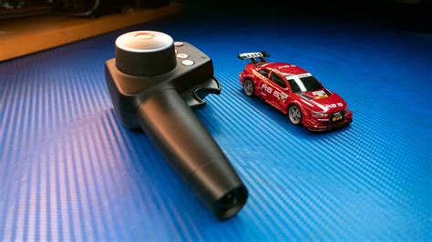 Download A Toy Car And A Remote Control Car On A Blue Surface ...