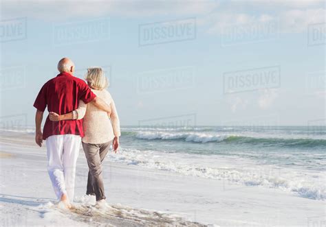 Senior couple walking on beach - Stock Photo - Dissolve