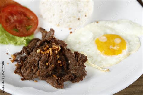 Tapsilog, a Filipino breakfast of beef tapa, fried rice and eggs Stock ...