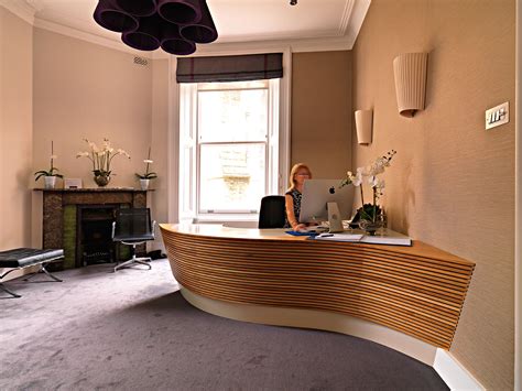 Bespoke curved reception desk from solid oak and Corian top surface ...