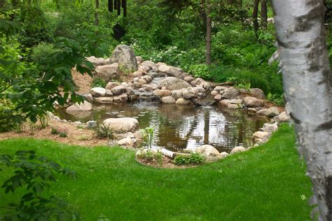 Large backyard pond with natural stone water feature in St. Paul, MN ...