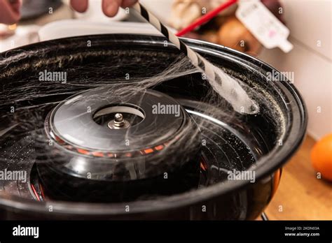 Operating a cotton candy machine Stock Photo - Alamy