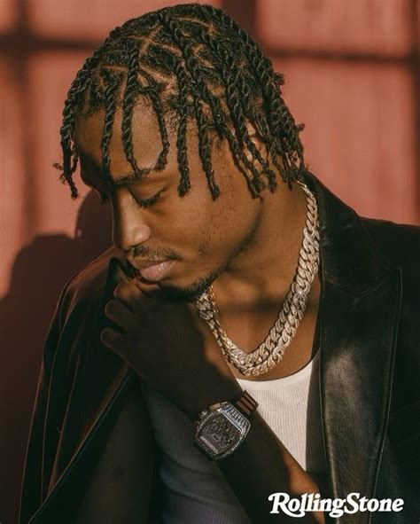 a man with dreadlocks and a watch on his wrist