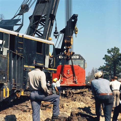 Amtrak SDP40F locomotive # 632, was derailed and is being lifted by two SCL Wrecker Cranes in ...