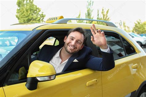 Male taxi driver sitting in yellow car — Stock Photo © belchonock ...