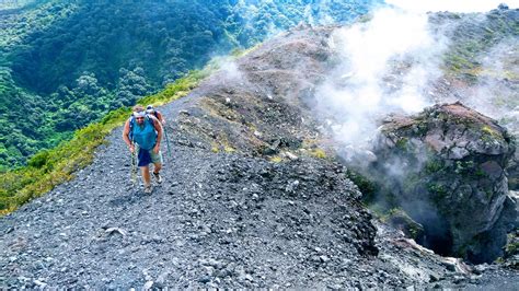 a man hiking up the side of a mountain with steam coming out of his back