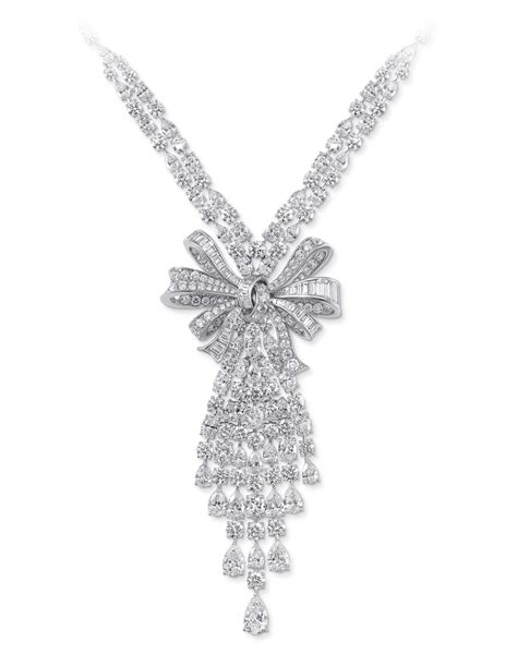 Diamond Bow Necklace This beautiful bow necklace features spectacular round and baguette ...