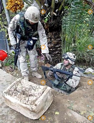 Photos and Pictures - U.s. Soldiers Demonstrate Access to the Spider Hole Used by Saddam Hussein ...