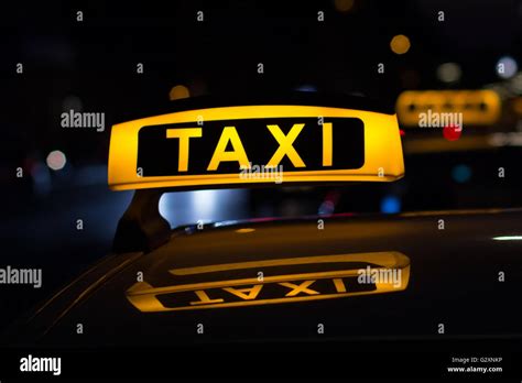 taxi sign at night - taxi cars Stock Photo - Alamy