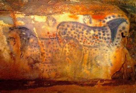 an animal painting on the side of a cave wall with other animals ...