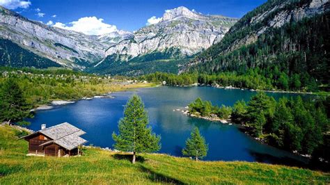 Rocky Mountains Forest With Pine Trees Lake With Turquoise Blue Water Wooden House On Green ...