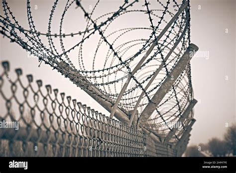 Prison fence. Barbed wire Stock Photo - Alamy