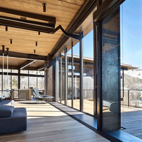 An entire glass wall swings upward to open this spacious retreat to the ...