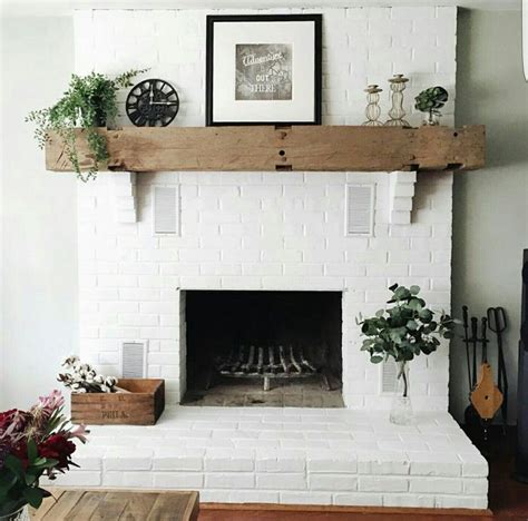 Brick fireplace painted white with a cedar mantle | White brick fireplace, Brick fireplace ...