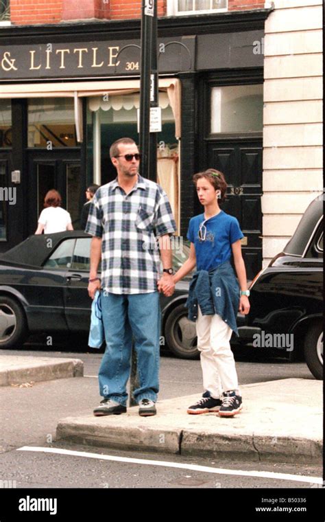 Eric Clapton musician and his daughter hold hands as they shop in the Kings Road London Stock ...