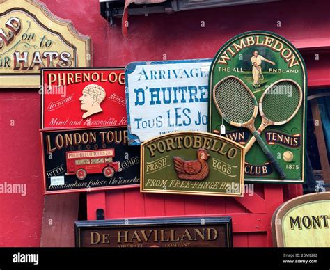 Old signs for sale outside a shop in the Portobello Road in London ...