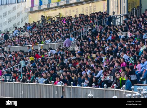 Crowded people in the auditorium watching the performance in a pulic ...