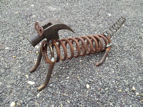 an old metal object laying on the ground with it's arms and legs exposed