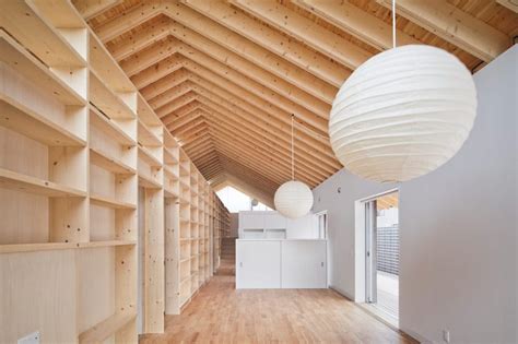 House With Exposed Timber Rafters And Bookshelf Columns