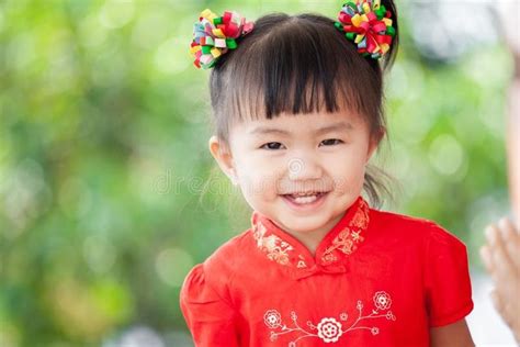 Happy cute asian child girl in chinese tradition dress smiling and ...