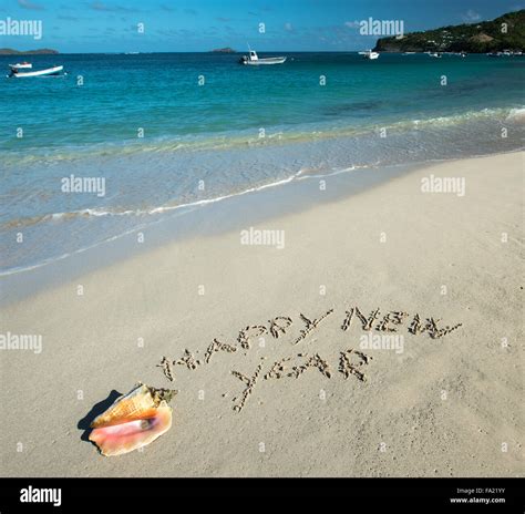 Happy new year written in the beach Stock Photo - Alamy