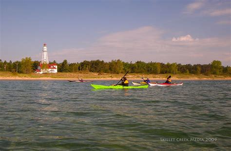 Kayakers pass the lighthouse at Point Beach State Park near Two Rivers, WI. | Wisconsin state ...