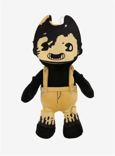 a small stuffed animal wearing overalls and a black t - shirt with an evil face