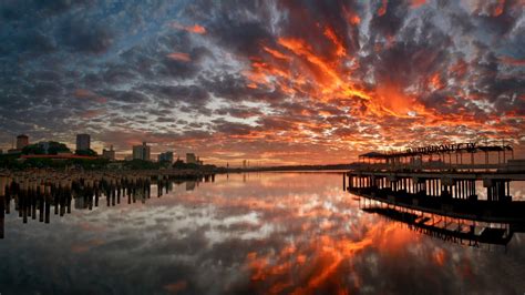 Stunning Sunset Reflections: HD Wallpaper of a City Pier