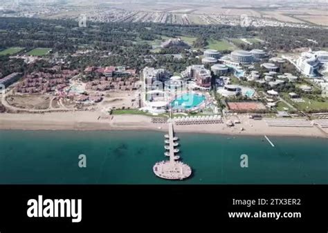 Aerial view on pier of luxury hotel, blue sea background. Video. Aerial ...